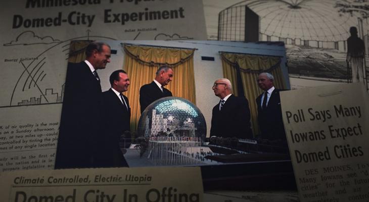 People talking in front of a domed city model