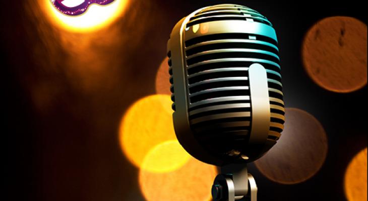 Microphone with lights in the background illuminating a purple mask