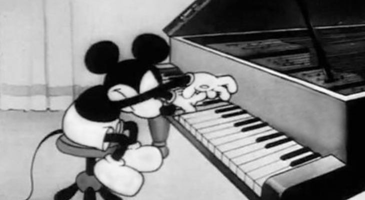 It's a black and white picture of Mickey Mouse playing the piano