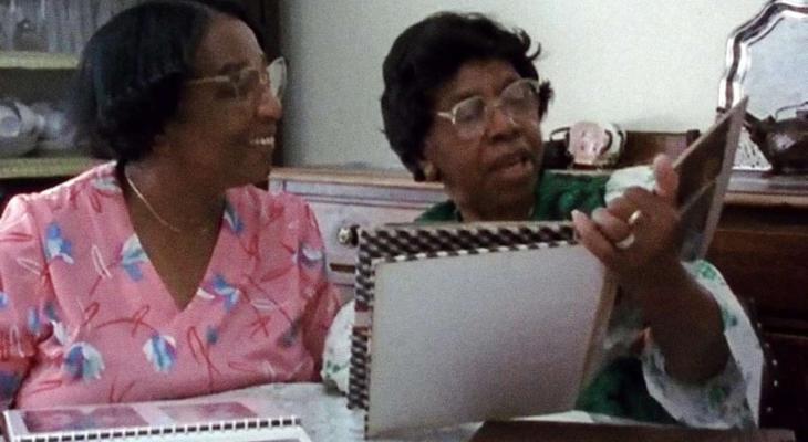 two people looking at a photo album