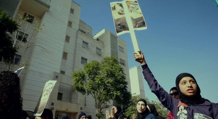 women holding up protest signs