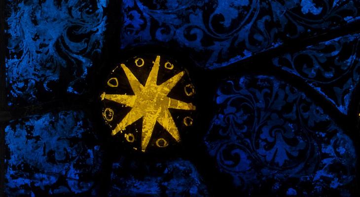 Detail of stain glass window - a gold star on a blue background