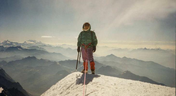 a woman standing on a mountain