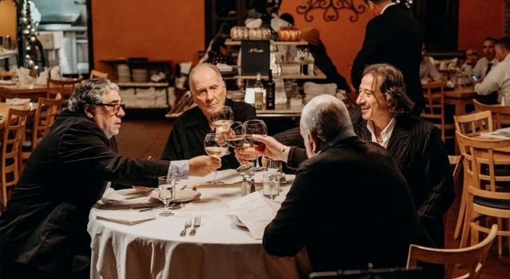 Sopranos cast members Federico Castellucio, Arthur J. Nascarella, Vincent Pastore, and Vincent Curatola cheers glasses of wine as they dine at a restaurant.