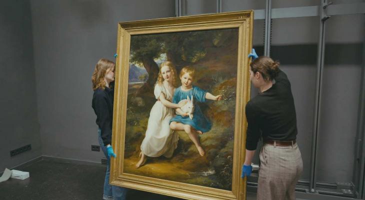 Gallerists move a painting.