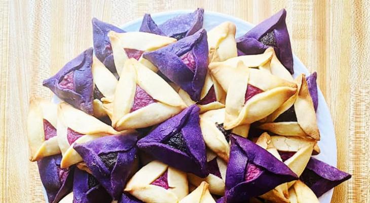 plate of purple and white triangle shaped cookies on a table