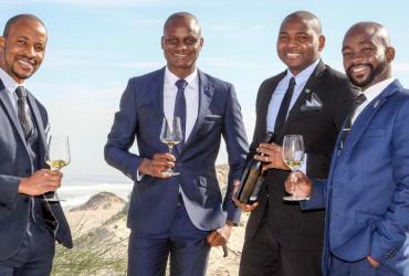 four men holding wine glasses