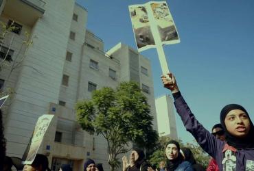 women holding up protest signs