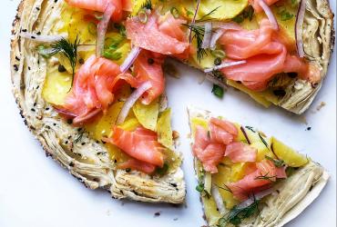 A flaky galette covered with smoked salmon, dill, red onion and potato.