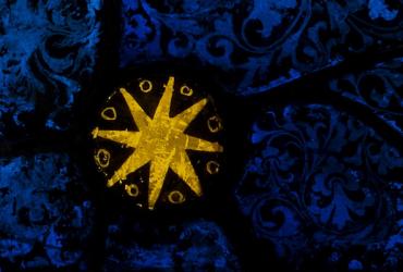 Detail of stain glass window - a gold star on a blue background