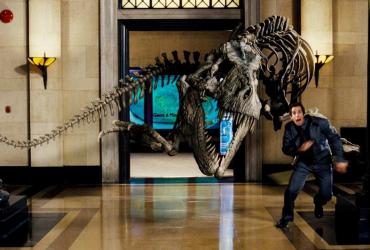Night guard runs away from dinosaur