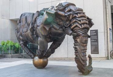 A statue of an elephant balancing on a ball