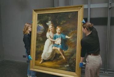 Gallerists move a painting.