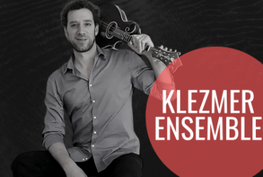 a photo of the leader of the program alongside the words "klezmer ensemble" written in a red circle beside him