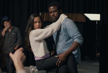 Actors take direction on a film set.