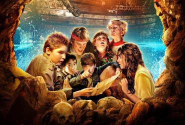 The Goonies look at their treasure map.