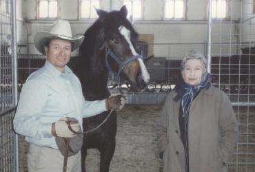 Horse trainer Monty Richards and the late Queen Elizabeth I share a moment with a horse in the stables.
