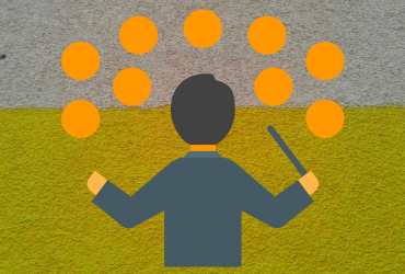 A man holding a conductor's wand facing orange blobs representing people