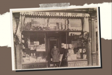 Greyscale picture of a man standing in front of Hymans Book & Arts Shop in Kensington Market 