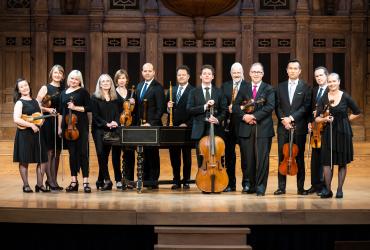 Tafelmusik Orchestra standing on stage at Jeanne Lamon Hall