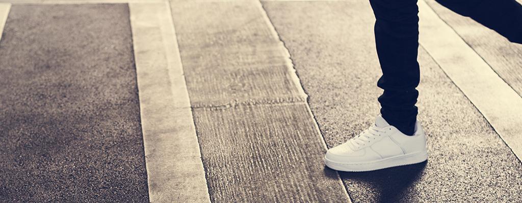 person's feet on pavement